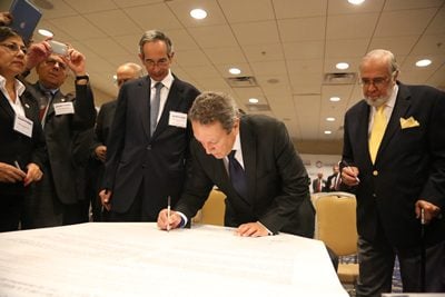 people signing a document
