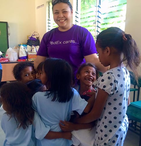 Global Peace Foundation Volunteer and local children share a moment of bonding.
