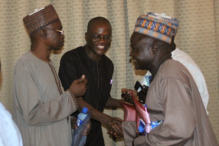 Leaders and stakeholders exchange greetings at the peace and reconciliation meeting