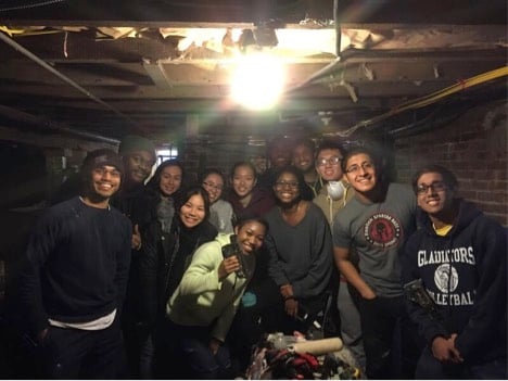 Volunteers in Far Rockaway huddle for a group photo in a home they helped to insulate