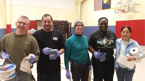 Volunteers show their excitement before they head to work at the Friendship House