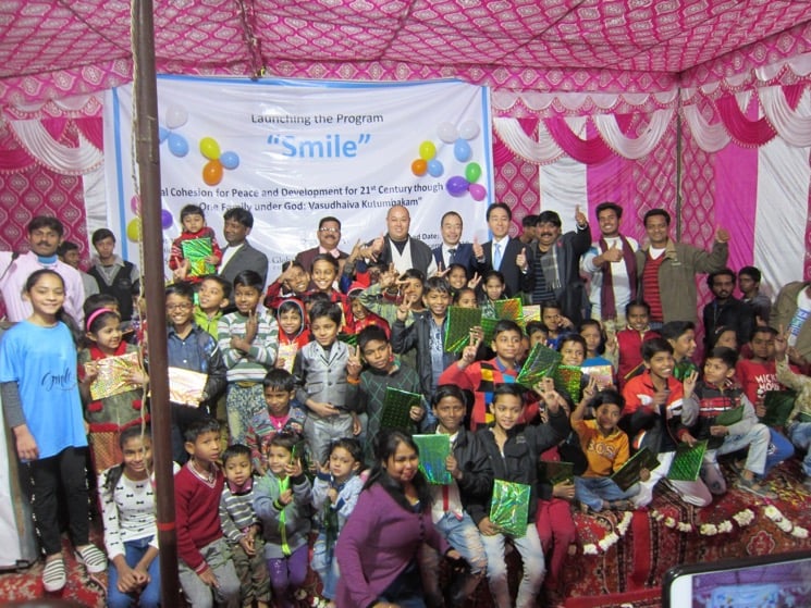 Children, volunteers, and local stakeholders at the launching of the Smile program