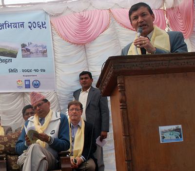 A man speaking at a podium in front of a crowd.