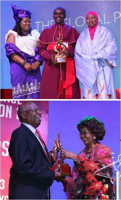 A group of people are holding awards in front of a group of people.