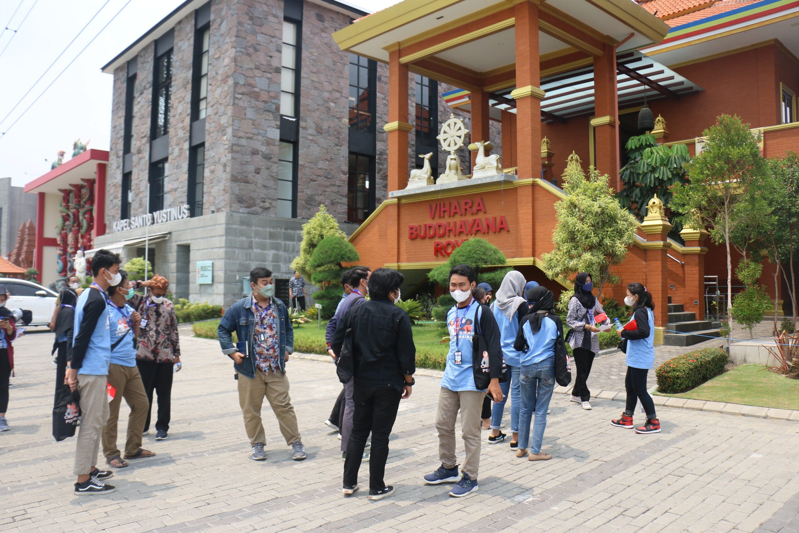 Young people standing in front of house of worship