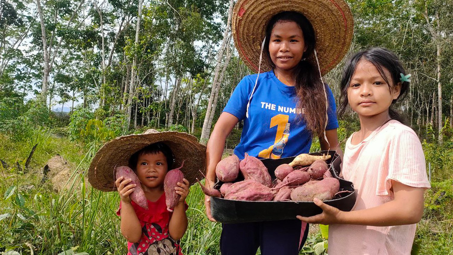 Orang Asli Amai proudly showing their harvested organic produce which include a variety of vegetables