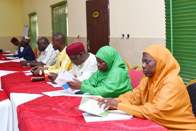 Nigeria Women Religious workshop A group of people sitting at a long table discussing strengthening religious leaders and security operatives in Nigeria.