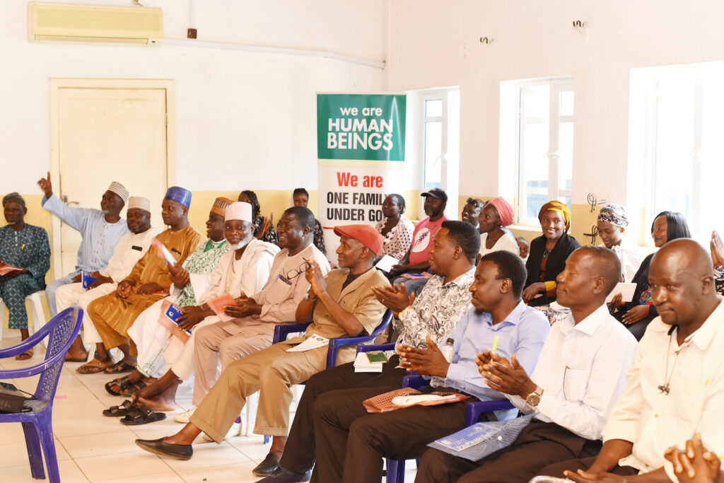 People receiving Bukuru mediation training in a room for conflict prevention.