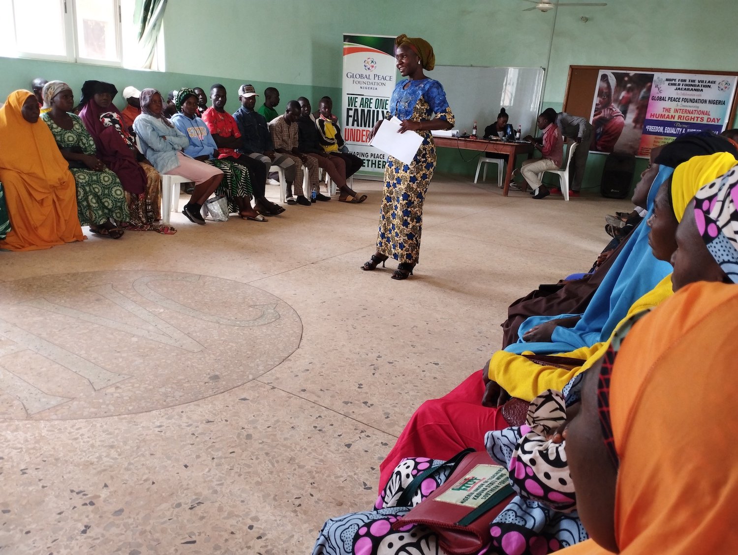 A group of people sitting in a circle to commemorate Human Rights Day in Nigeria.