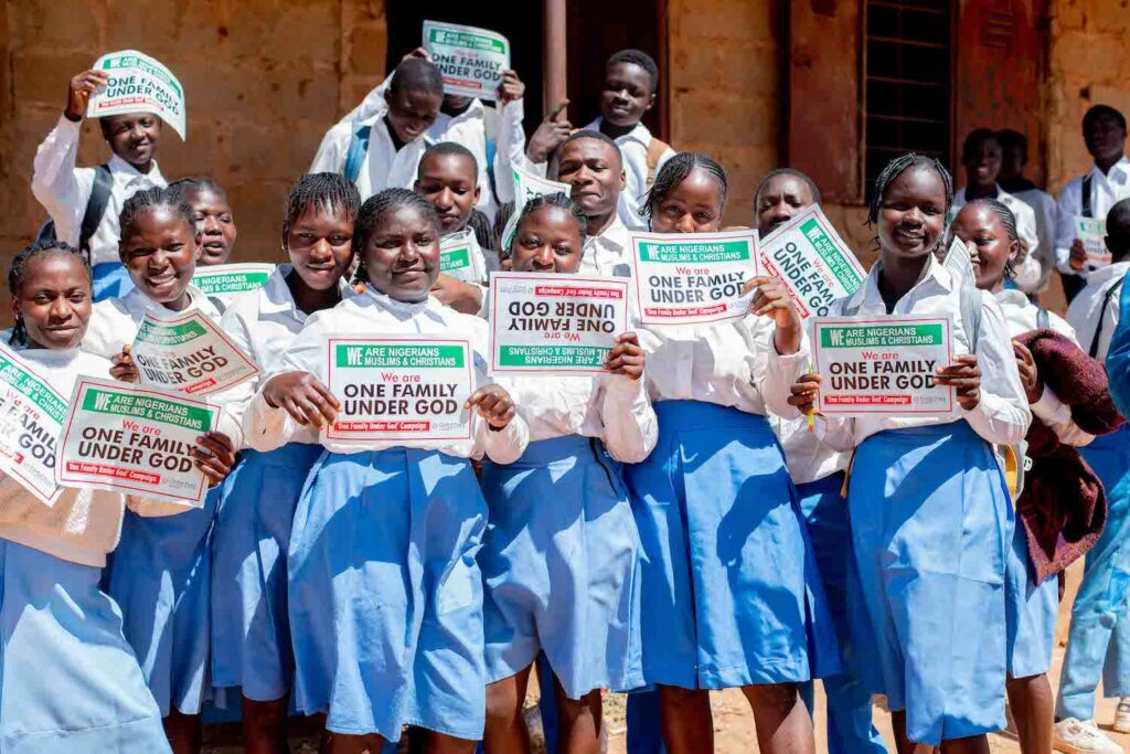 A **community service project** group **holding signs**.