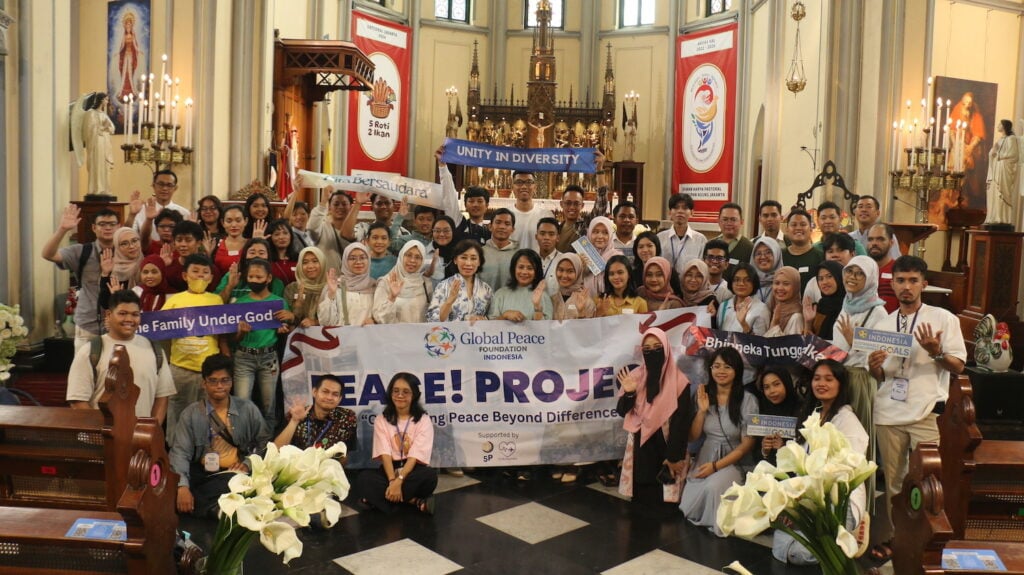Group of individuals posing with banners for a photo at a