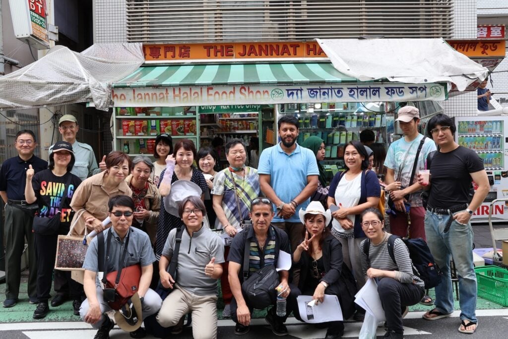A group of people pose cheerfully in front of